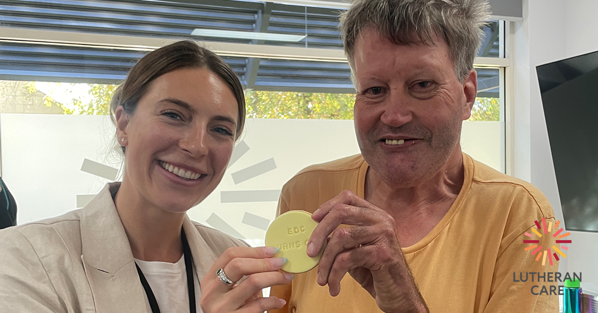 Image of Abbey and Paul holding an EDC Turns One cookie at the one year birthday celebration