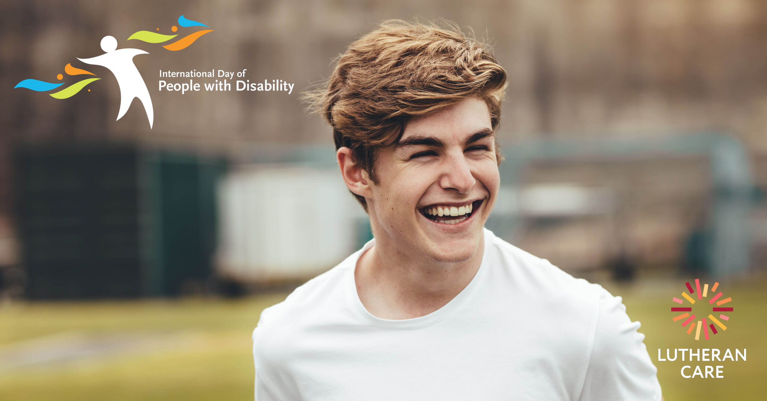 Teenage boy is outside laughing at something off camera. The International Day of People with Disability and Lutheran Care logos appear on the image as well.