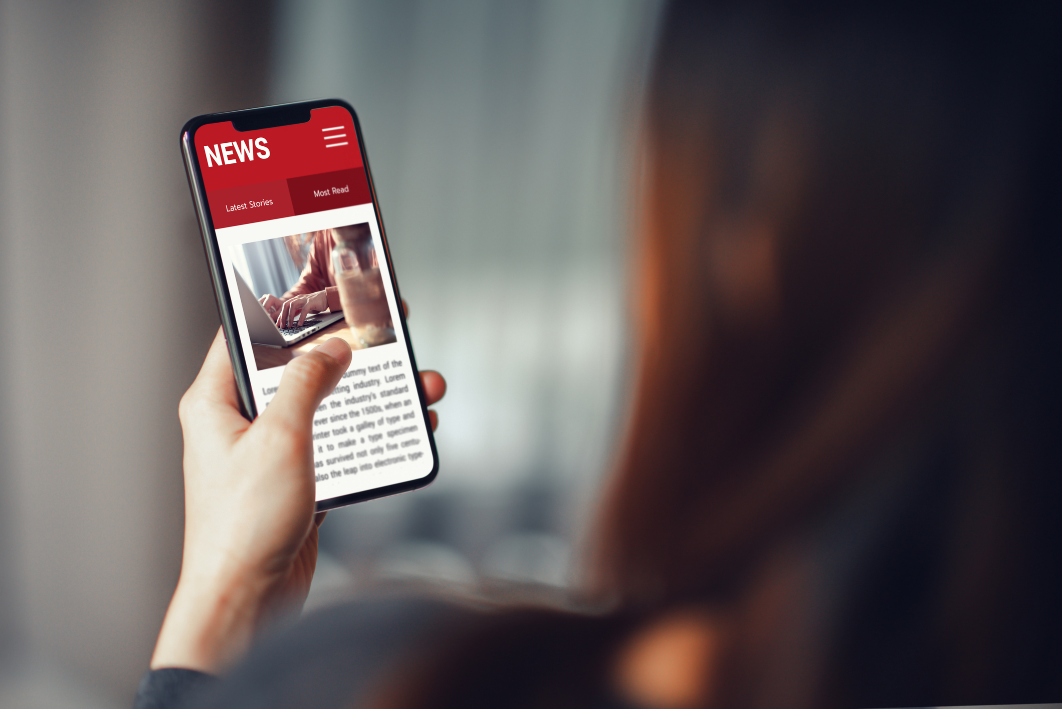 Online news on a smartphone. Mockup website. Woman reading news or articles in a mobile phone screen application at home. Newspaper and portal on internet.