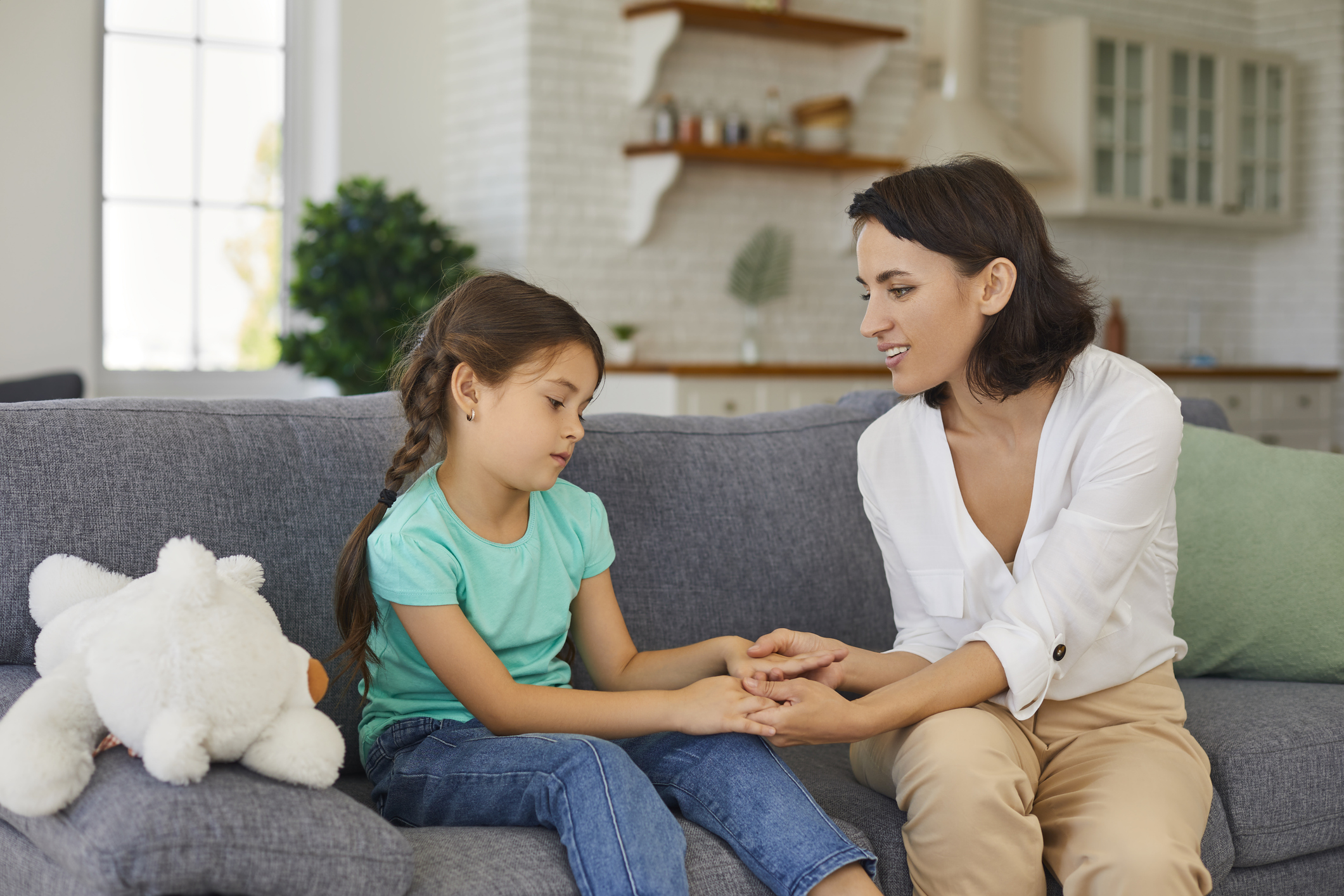 Sad girl communicating with speech pathologist.