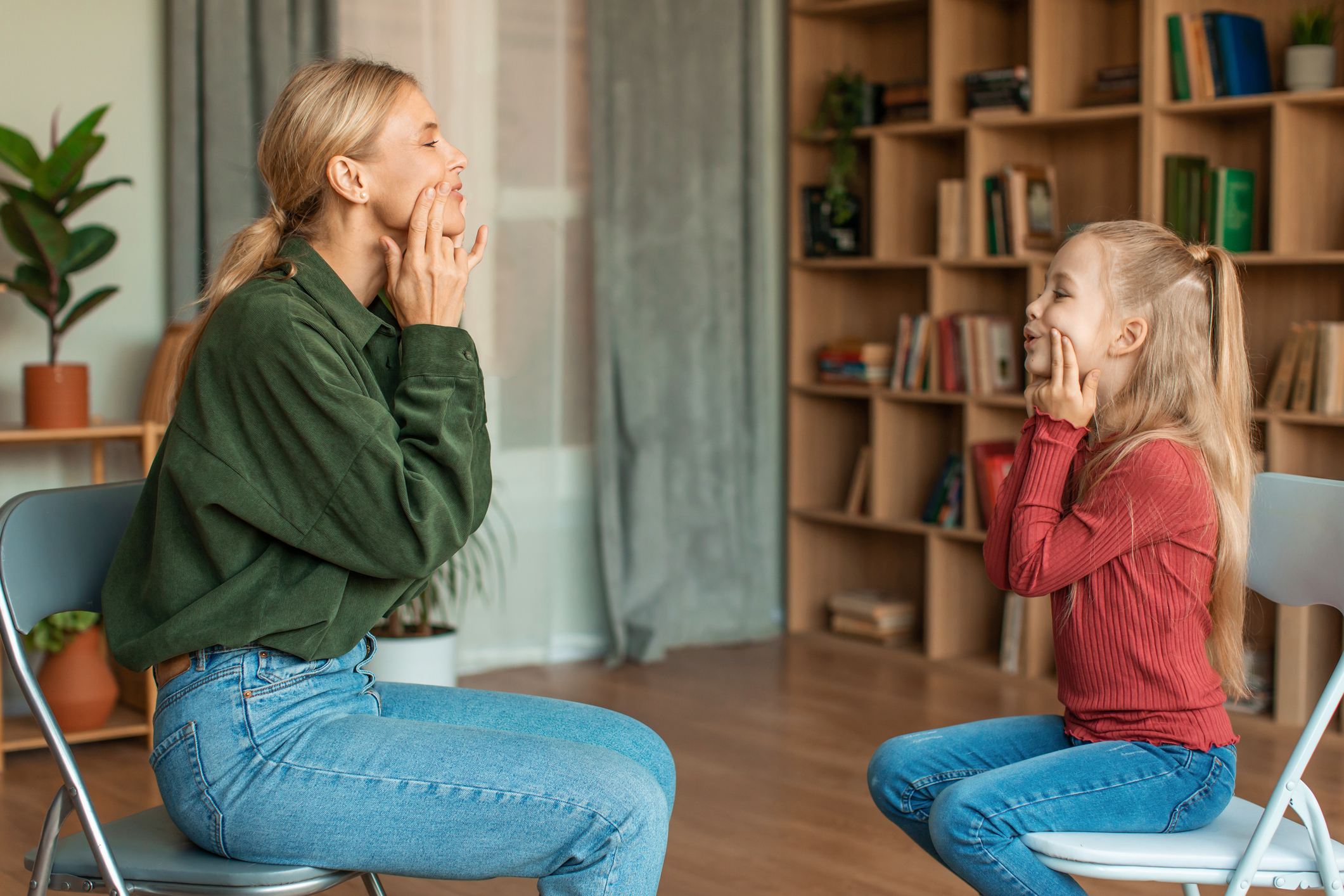 Speech Pathologist works with a young client in a session.