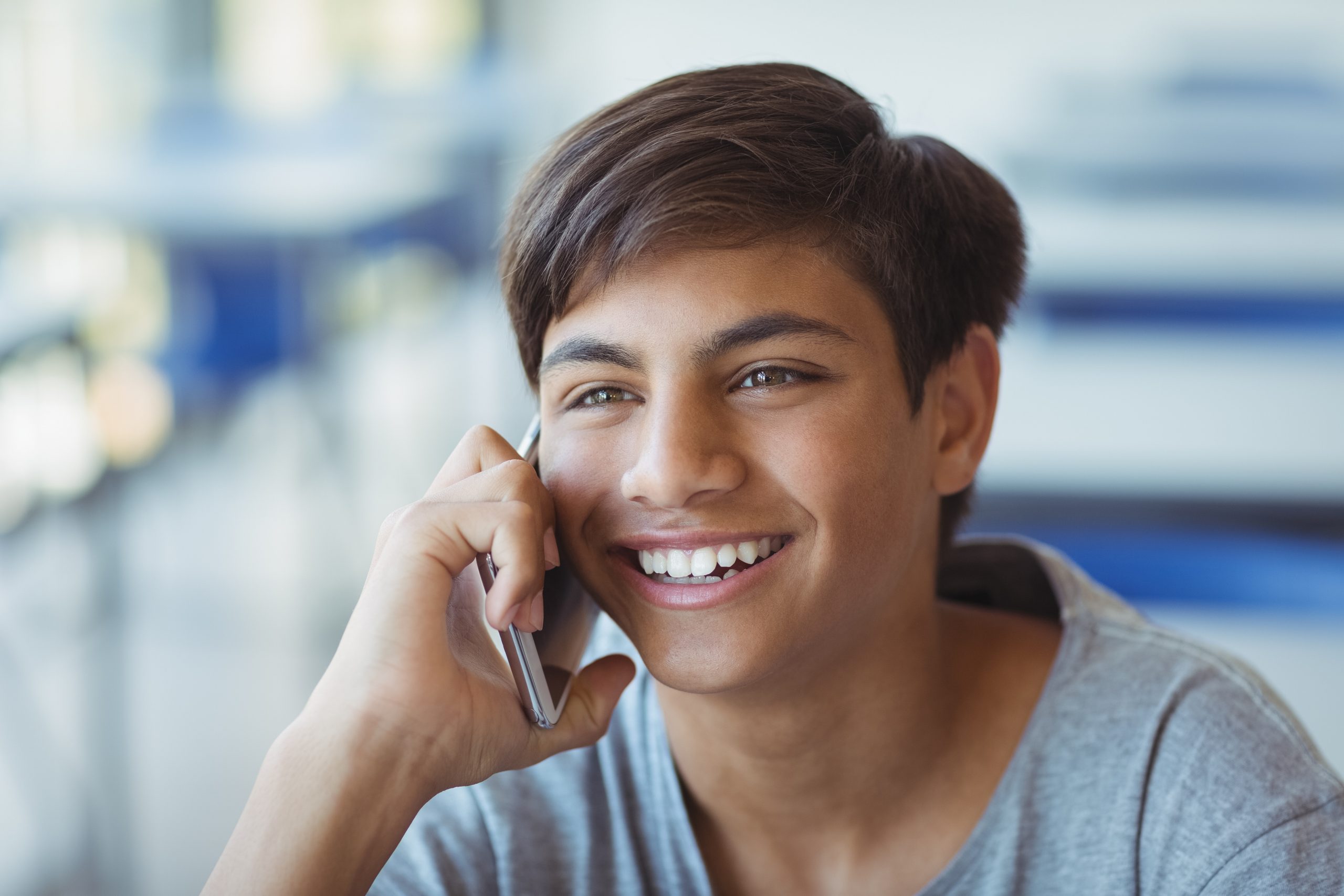 Teenage boy talks to someone on phone.